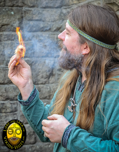 demonstrating firelighting as part of a Viking school visit.